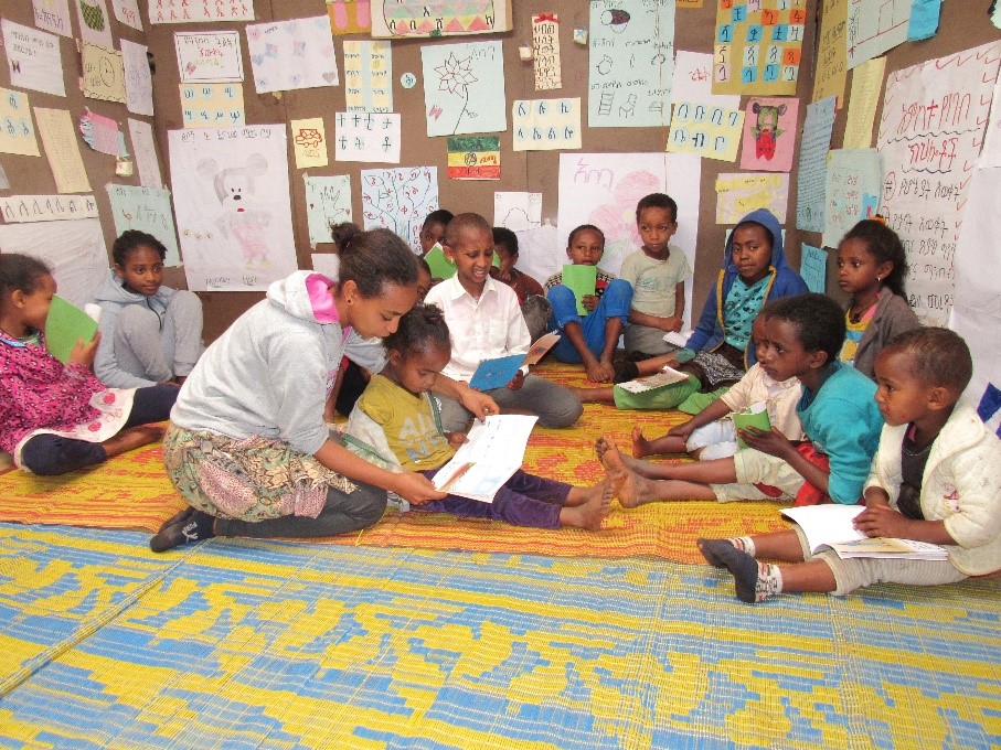 Female reading camp leader provides inspiration for girls while helping